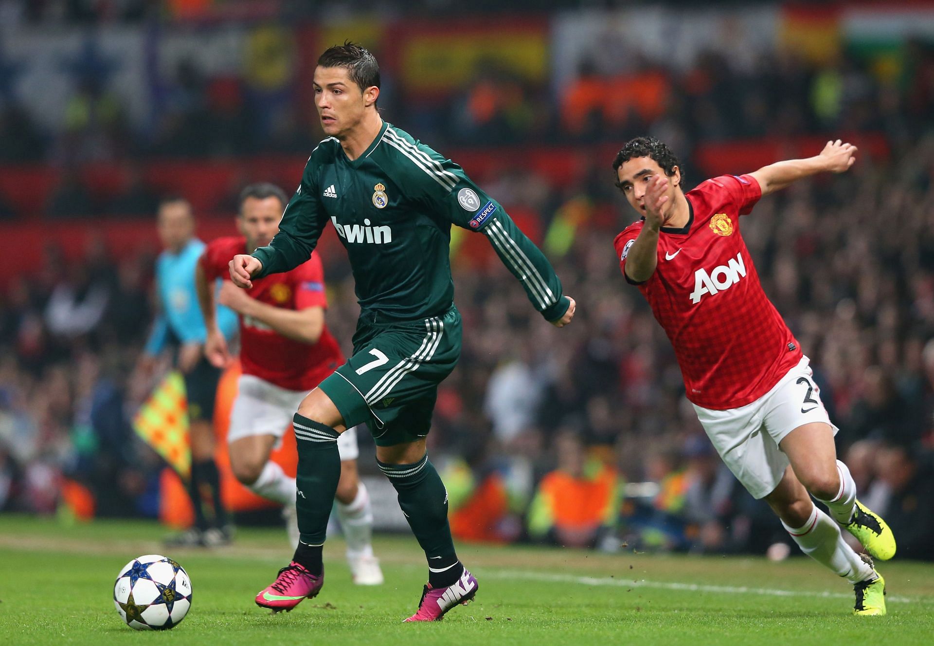 Cristiano Ronaldo of Real Madrid (#7) gets past Manchester United's Rafael da Silva.